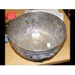 An Indian metal bowl with repousse decoratio