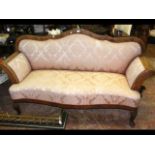 An antique three seater settee with serpentine fro