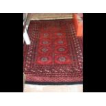 A Middle Eastern rug with geometric border and red