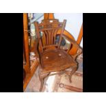 A hardwood armchair with decorative carved backres