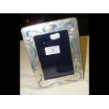 A large silver and enamel photo frame