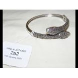 A large silver 'snake' bracelet