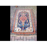 An antique Middle Eastern carpet with geometric bo