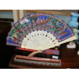 A decorative antique ivory oriental fan with hand painted