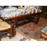 An antique style oak refectory table on turned sup