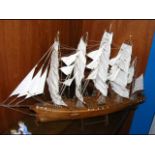 A wooden model ship on stand