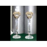 A pair of Swarovski candlesticks with flowers to t