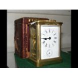 A brass cased carriage clock with alarm - 11.5cm high