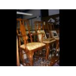 A set of six oak dining chairs with cabriole front