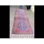 An antique Middle Eastern runner with geometric bo