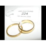 A lady's 22ct gold wedding band, together with one