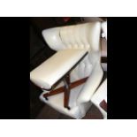 A retro swivel button back wing easy chair with ma