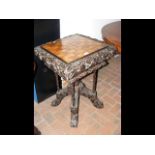 A heavily carved Victorian games table - 54cm x 54
