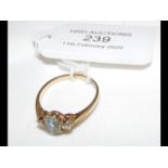 A lady's blue stone and diamond ring in 9ct gold s