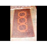 A small Middle Eastern rug with dark red ground -