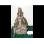 A Sino-Tibetan bronze deity holding an animal in i
