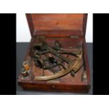 An antique sextant, the brass and silver scale with