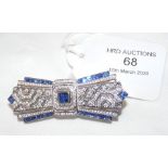 A solid silver brooch set with sapphires and cubic