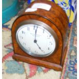 A 15cm high walnut cased mantel clock