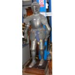 A reproduction suit of armour on stand - 6ft high