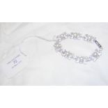 A solid silver bracelet set with pearls