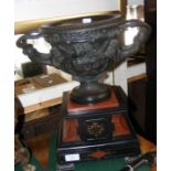 A bronze Warwick vase, mounted on rouge and black