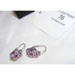 A pair of white gold diamond and ruby earrings in