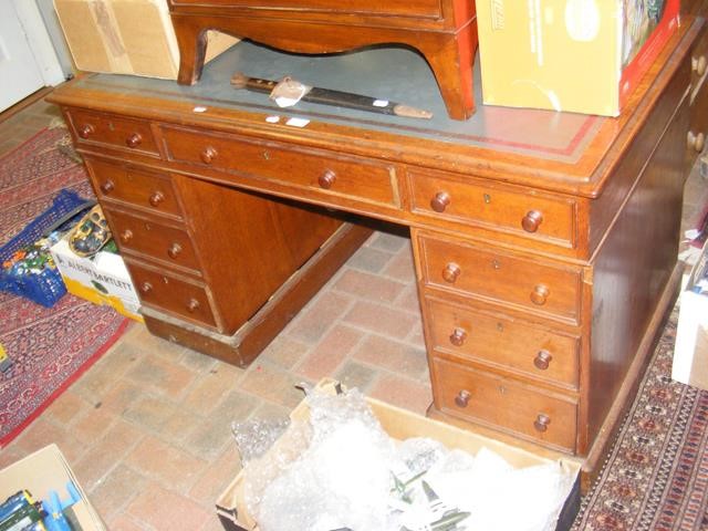 A Victorian pedestal desk with nine drawers to the