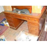 A Victorian pedestal desk with nine drawers to the