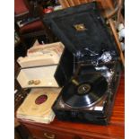 A portable HMV gramophone with various records