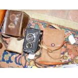 Two collectable cameras and carrying cases