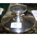 A silver capstan inkwell