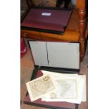 A folder containing collectable antique maps, toge