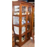A hardwood display cabinet enclosed by a pair of f