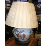 A large bulbous oriental table lamp on wooden stan