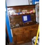 A Georgian oak country dresser with plate rack ove