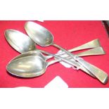 Four heavy silver serving spoons