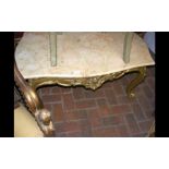 A decorative marble top table with gilt base