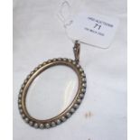 An antique large silver and gold coloured locket s