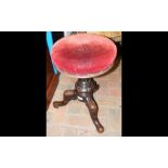 An antique revolving piano stool