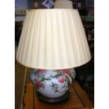 A large bulbous oriental table lamp on wooden stan