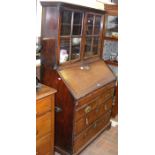 A Georgian mahogany bureau bookcase with well to i