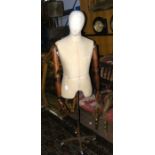 An old dressmaker's manikin on metal stand