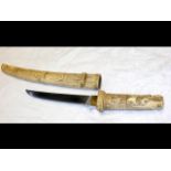 An antique Japanese 44cm long dagger with carved i