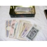 A tin with old world banknotes (110 plus)