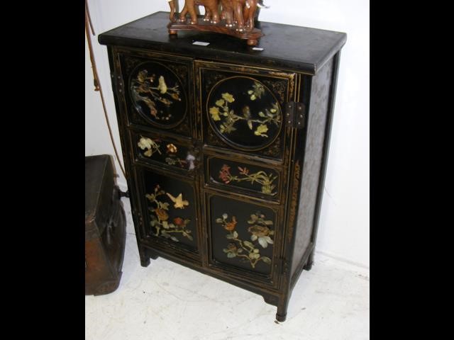 A small proportioned oriental two door cupboard wi