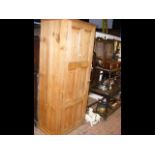 An antique pine hall cupboard