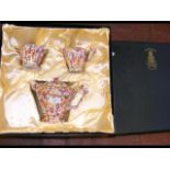 A boxed three piece tea set in the chintz style
