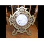 An unusual brass mantel clock with pierced shaped