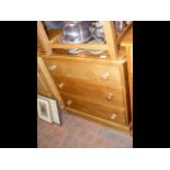 An antique pine chest of three long drawers